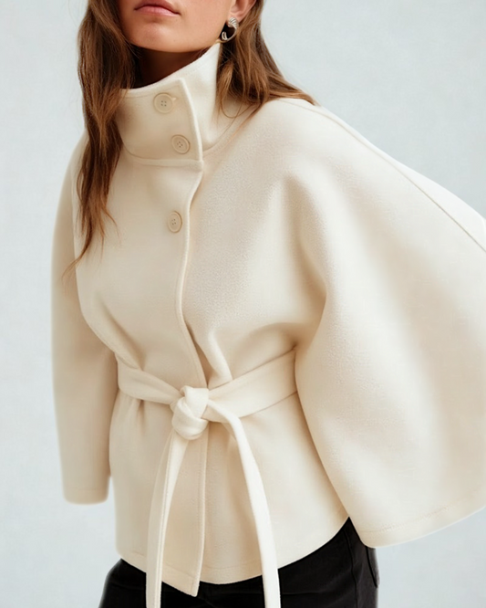 Beige coat with a belt on a plain background